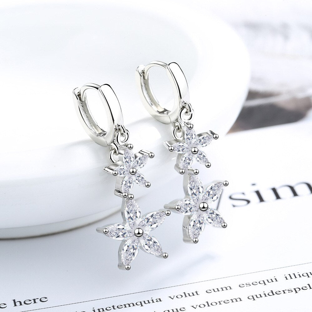 925 Sterling Silver high grade shiny CZ Stones make the earrings shiny. The dangle features water droplets