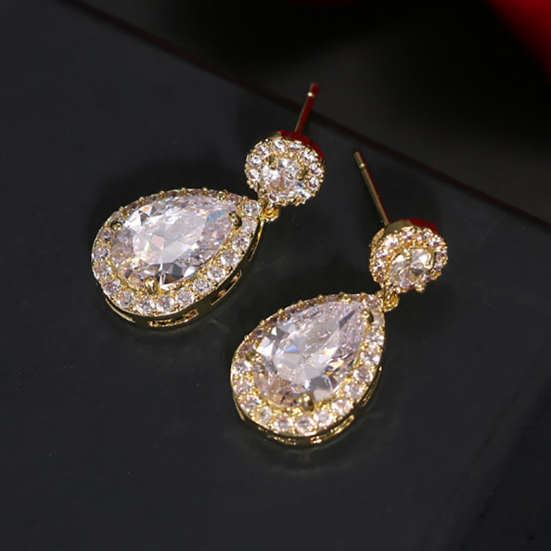 Gold white CZ dangle drop earrings featuring  yellow gold plated with grade AAA marquise teardrop Cubic Zirconia crystals for a diamond-like brilliance.