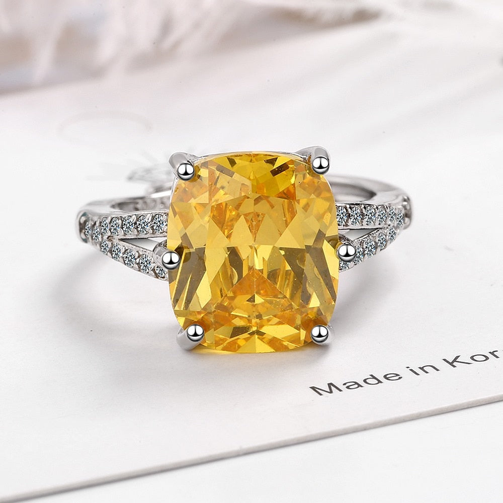 Simple but luxurious, this ring features a 2-carat Geometric Cubic Zirconia Width: of 12mm, surrounded by many micro CZ stones, and set in a 4-prong setting, looks pretty stunning and shiny.